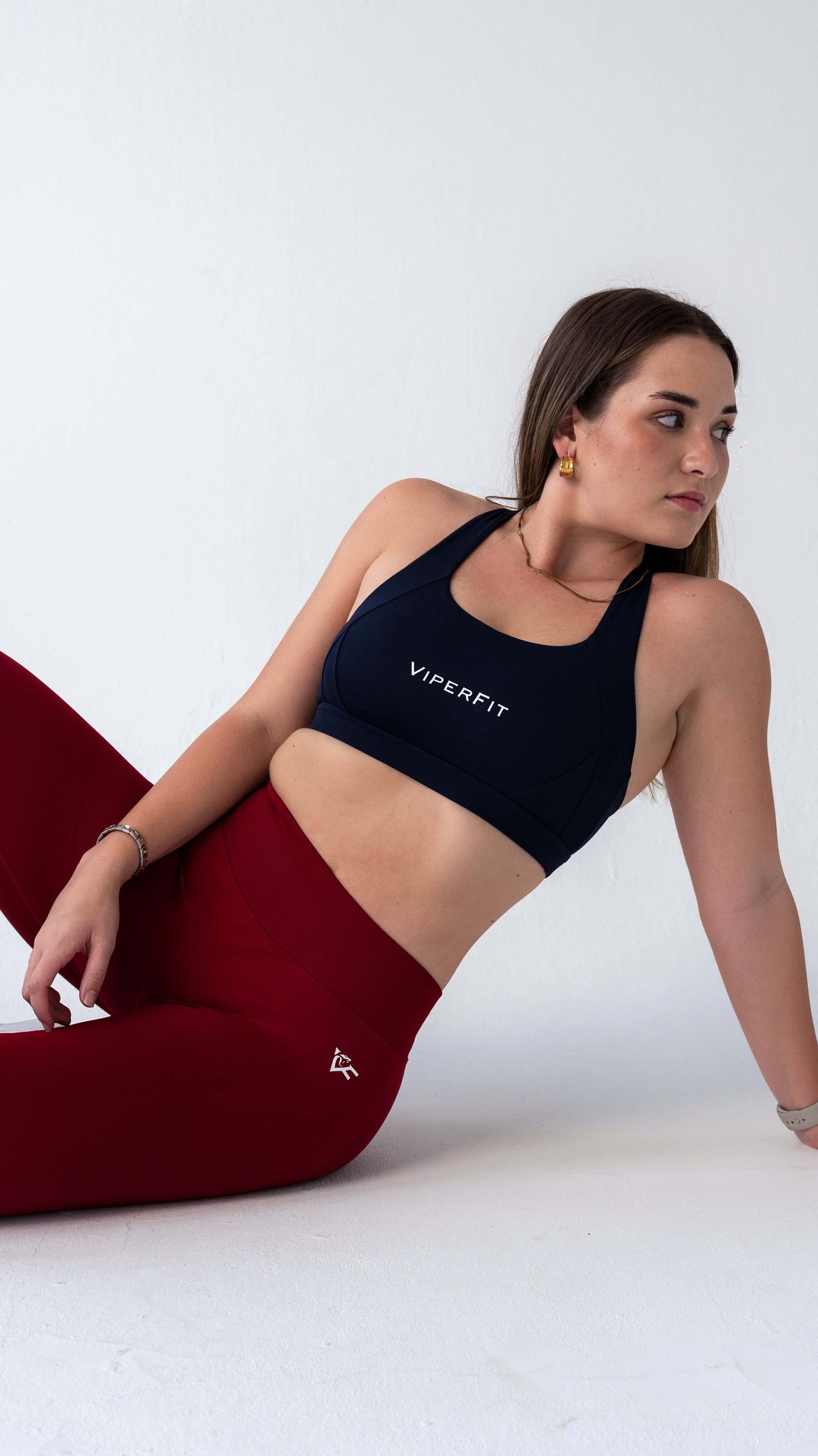 Model seated in ViperFit Luxe Pro Leggings - Wine showing the thick, smooth, seamless sculpting fabric.