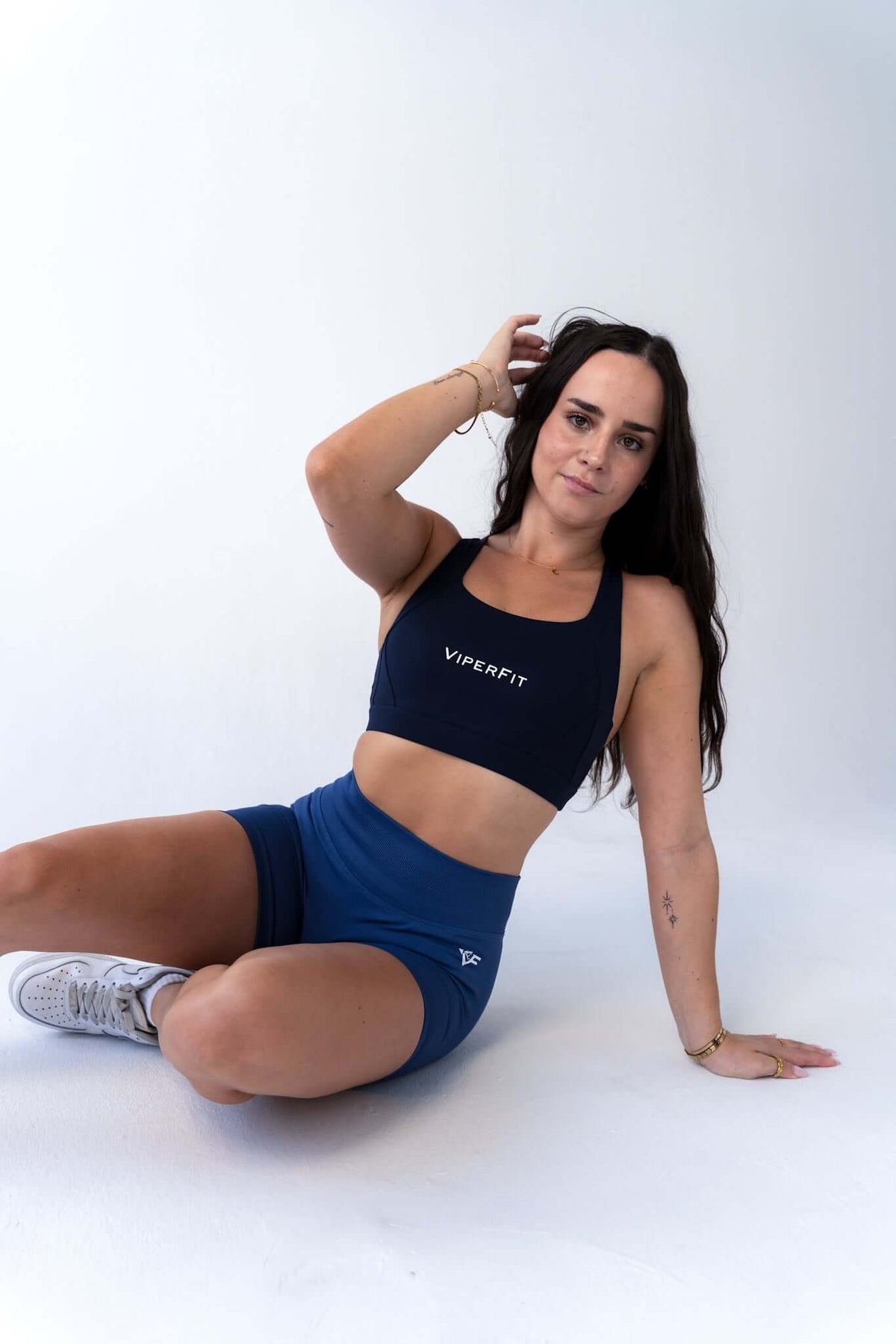 Model seated in ViperFit Luxe Pro Shorts - Gray Blue showing the high-waisted compressive fit.