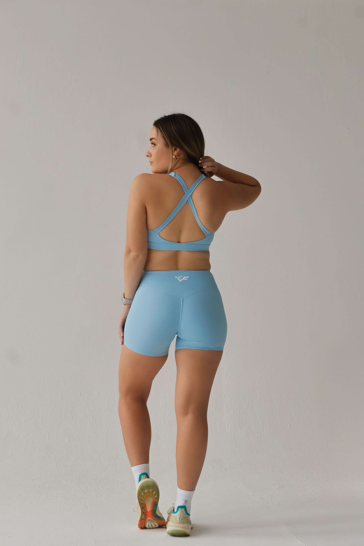 ViperFit Pulse Shorts - Sky Blue featuring a model in a light blue sports outfit.